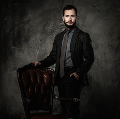Handsome well-dressed  standing leather chair