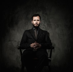 Handsome well-dressed  sitting in leather chair