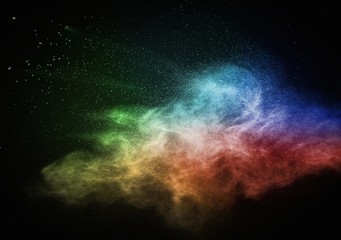 Colourful powder exploding isolated on black