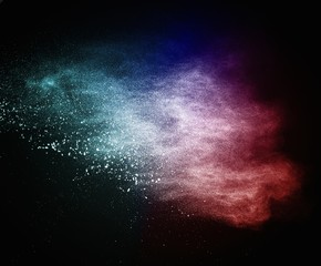 Colourful powder exploding isolated on black
