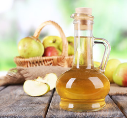 Obraz na płótnie Canvas Apple cider vinegar in glass bottle and ripe fresh apples,