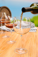 Red wine pouring into wine glass, close-up