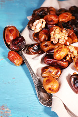 Tasty dates fruits on blue wooden table