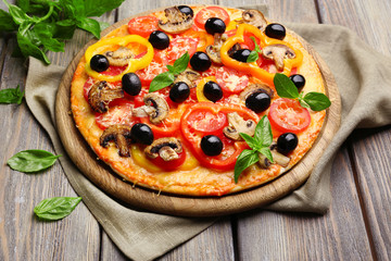 Delicious pizza served on wooden table