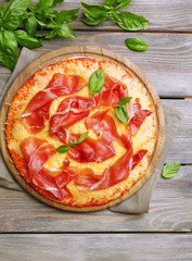 Delicious pizza served on wooden table