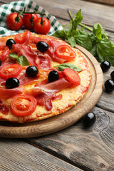 Delicious pizza served on wooden table