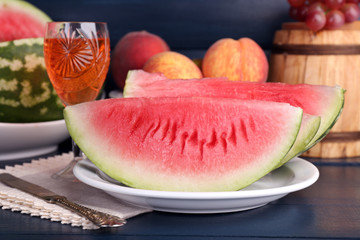 Composition of ripe watermelon, fruits, pink wine in glass and