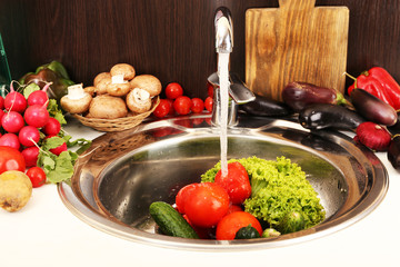 Fresh vegetables in sink in kitchen