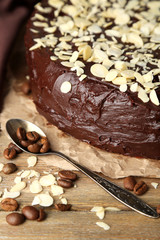 Tasty chocolate cake with almond, on wooden table