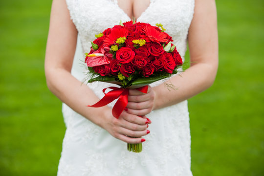 Bride With Red Wedding Bouquet In Hand