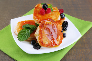 Tasty pancakes with fresh berries, honey and mint leaf