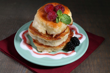 Tasty pancakes with fresh berries and mint leaf