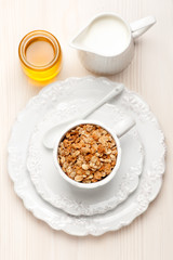 Granola muesli with honey and milk. Healthy breakfast.