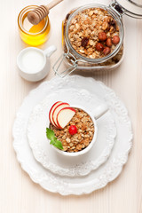 Granola with honey, fruit, nuts and milk. Healthy breakfast