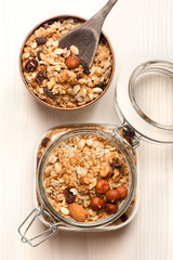 Granola with nuts on wooden background. Healthy breakfast.