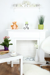 Fototapeta na wymiar Fireplace with beautiful decorations in comfortable living room