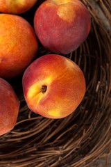 Fresh peaches on wood background. Selective focus.
