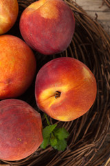 Fresh peaches on wood background. Selective focus.