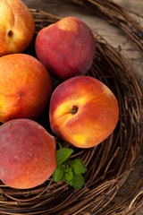 Fresh peaches on wood background. Selective focus.