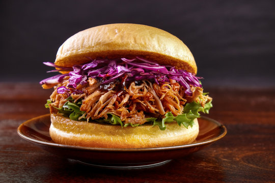 Pulled pork burger with red cabbage salad on plate