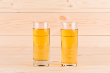 Apple juice on wooden table.