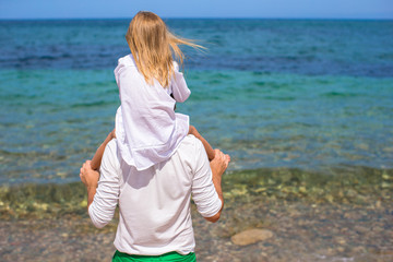 Fototapeta na wymiar Happy father and adorable little daughter on the beach