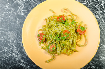 Pasta with basil pesto and pine nuts, cherry tomatoes
