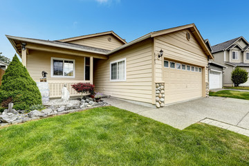 House exterior with stone trim. Entance porch and front yard des