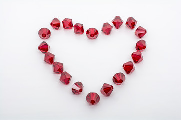 Macro Shot of A Collection Of Red Beads In Form Of A Heart
