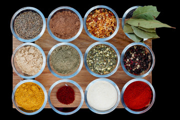 Set of various spices on wooden plank