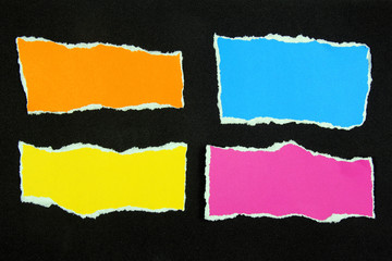 colorful torn paper on black paper background