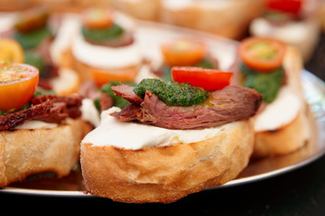 Bruschettas with beefsteak and pesto sauce