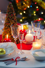 Candlelight on a table decorated beautifully for Christmas
