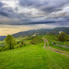Fototapeta na wymiar fence on hillside meadow in mountain