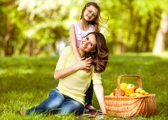 Mother and daughter having fun in the autumn park