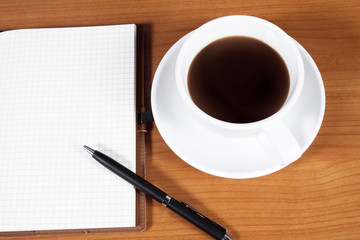 Obraz na płótnie Canvas Open a blank white notebook, pen and cup of coffee on the desk