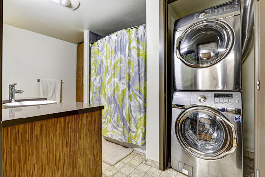 Modern steel laundry appliances in bathroom