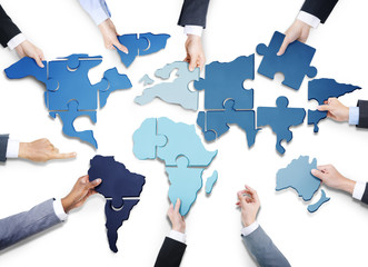 Business People with World Jigsaw Puzzle Forming