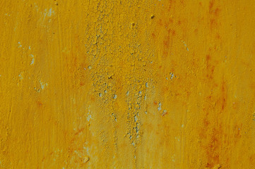 Yellow cracked paint on rusty background
