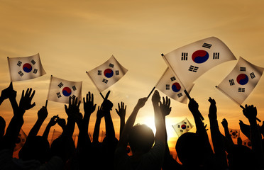 Silhouettes of People Holding Flag of South Korea