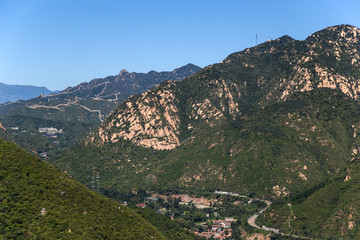 Fototapeta na wymiar Mountains and section of the Great Wall in the background