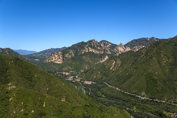 Fototapeta na wymiar Mountain valley. Section of the Great Wall in the background