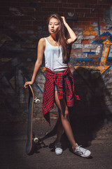 teen girl with skate board. Outdoors, urban lifestyle.