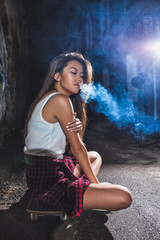 asian woman sitting on skate and smoking