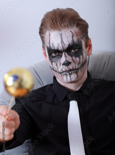 portrait young man with skull makeup halloween face art