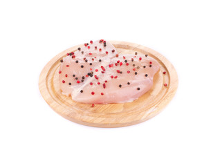 Raw chicken fillet on wooden board.