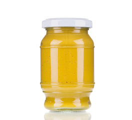 Glass jar full of mustard.