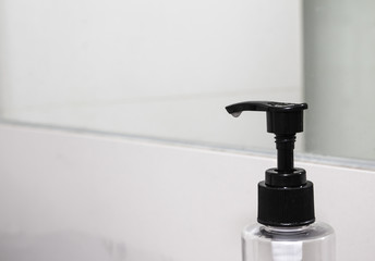 Fototapeta na wymiar Liquid soap bottle on the sinks in modern bathroom