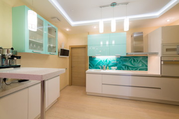 Beautiful modern kitchen with TV and coffee machine.