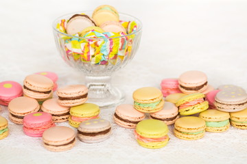 Colorful cookies with cream on table and in glass vase